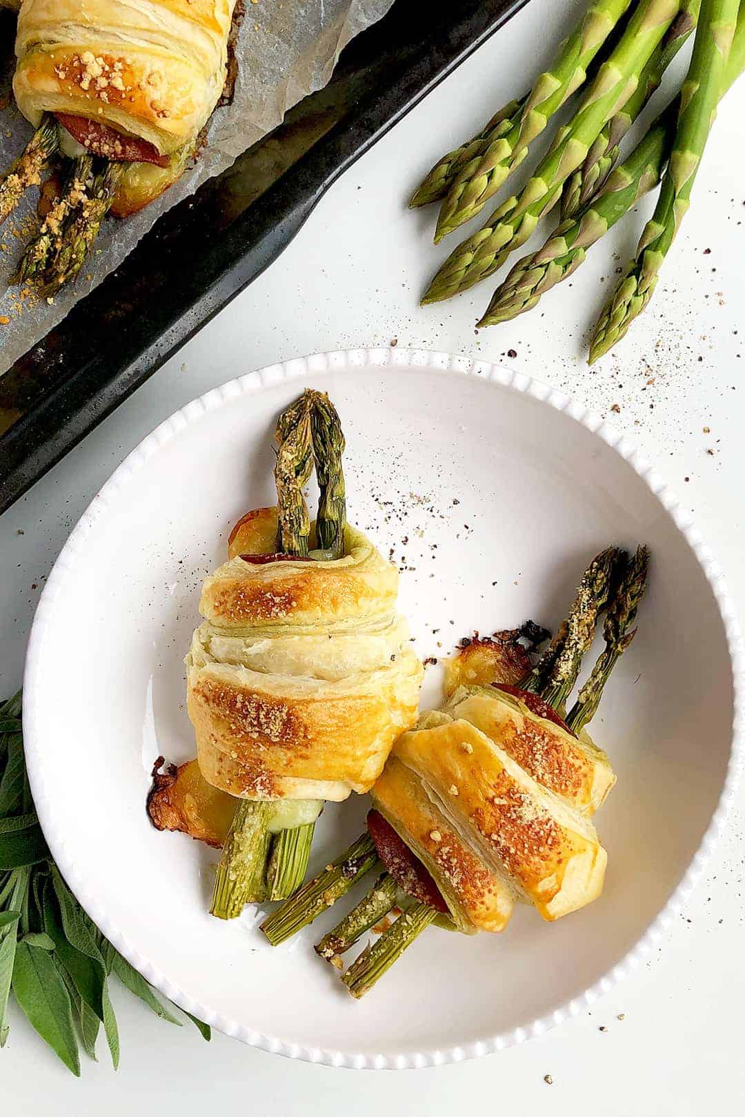 Golden brown puff pastry rolls with asparagus