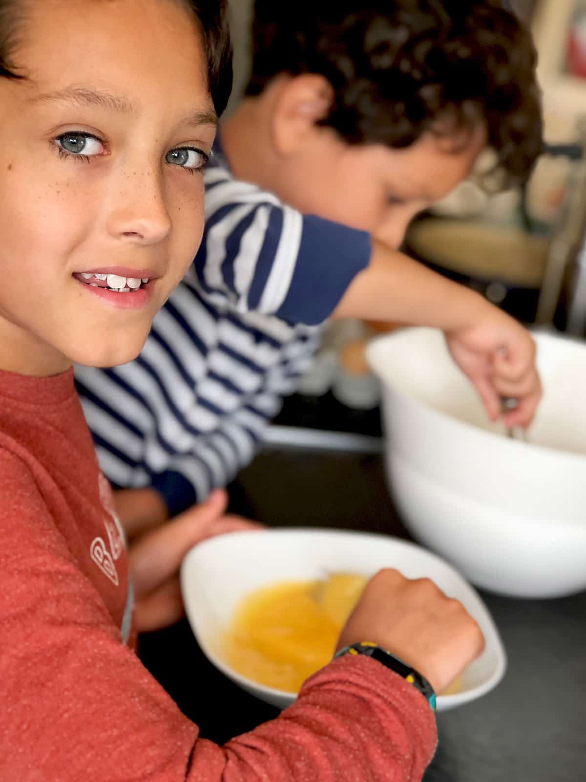 children preparing toad in the hole batter