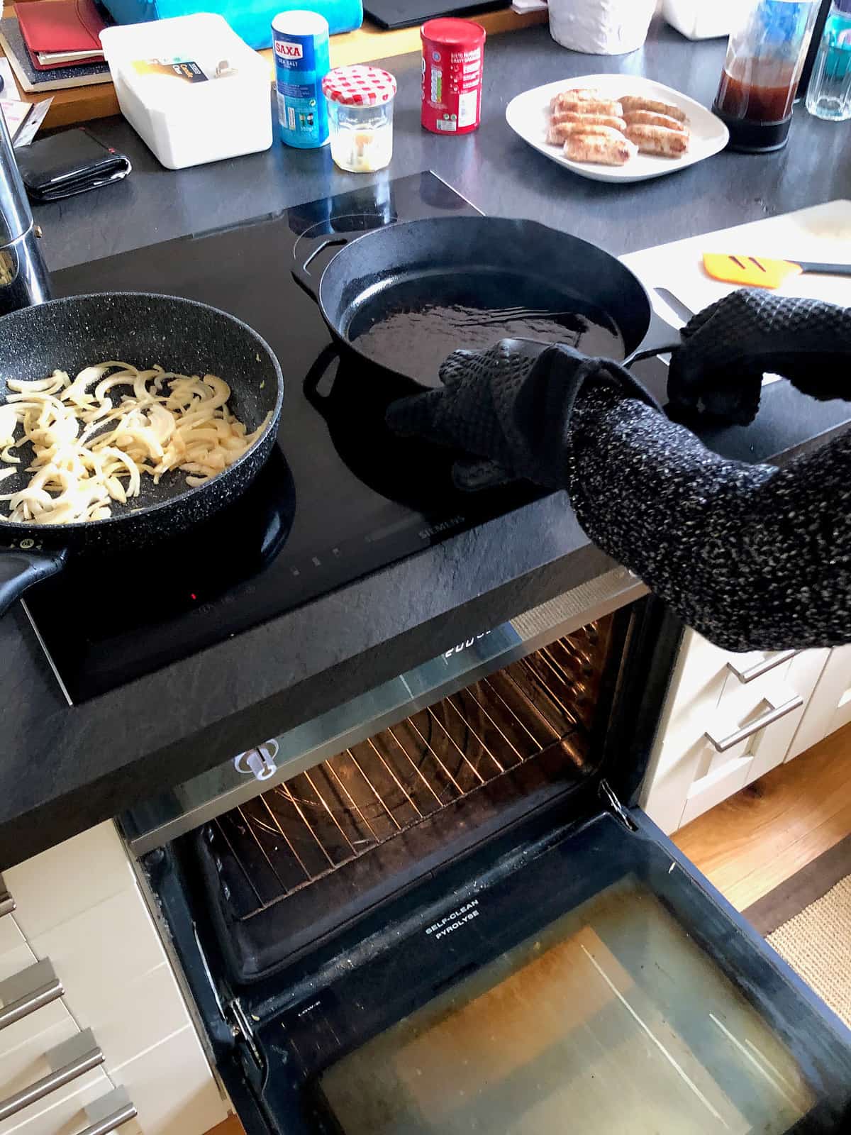 Holding hot cast iron pan with silicon gloves