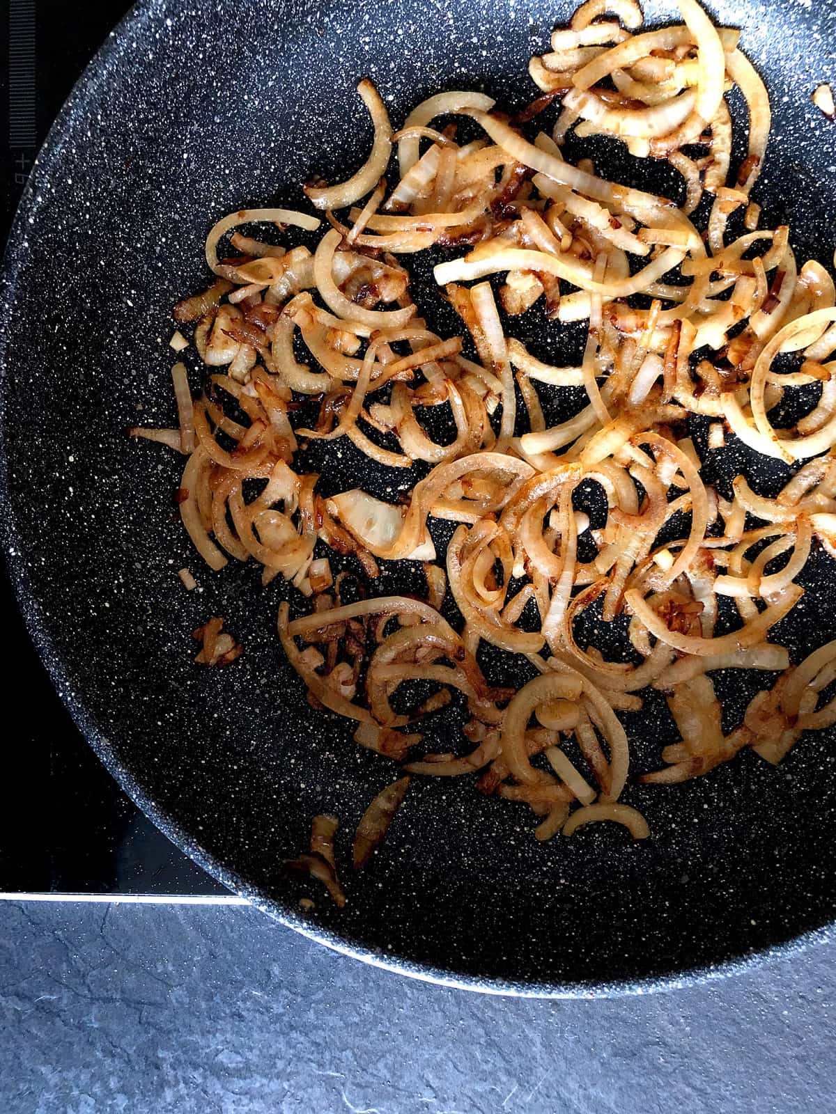 Browning onion in a pan
