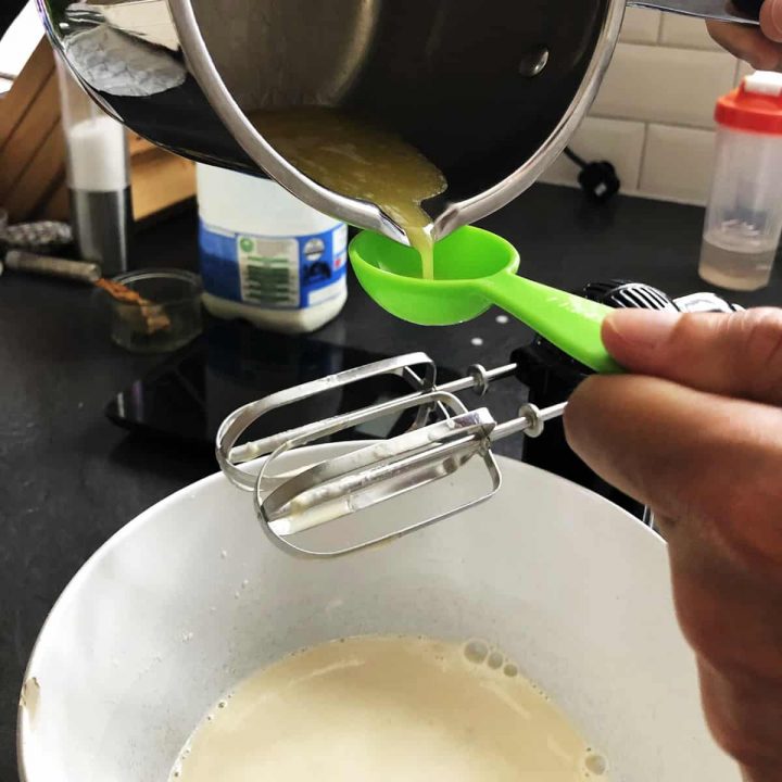 spooning butter into the pancake mix