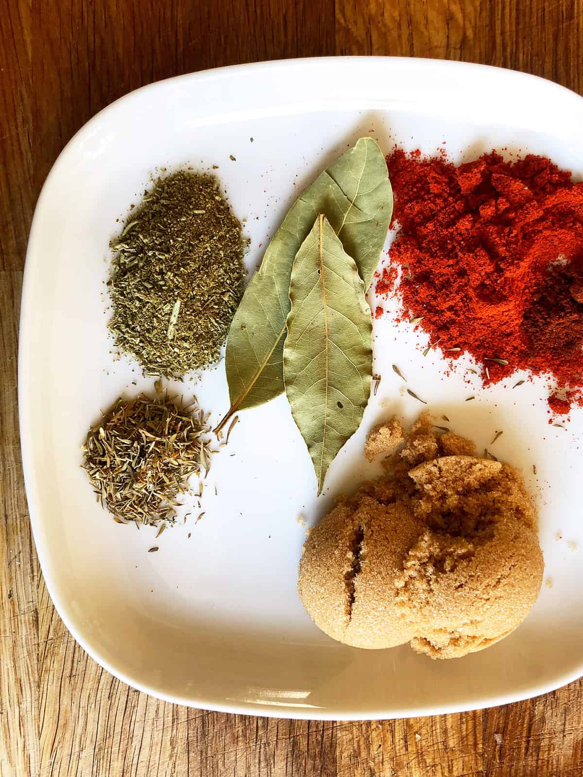 A plate with dry herbs and paprika powder