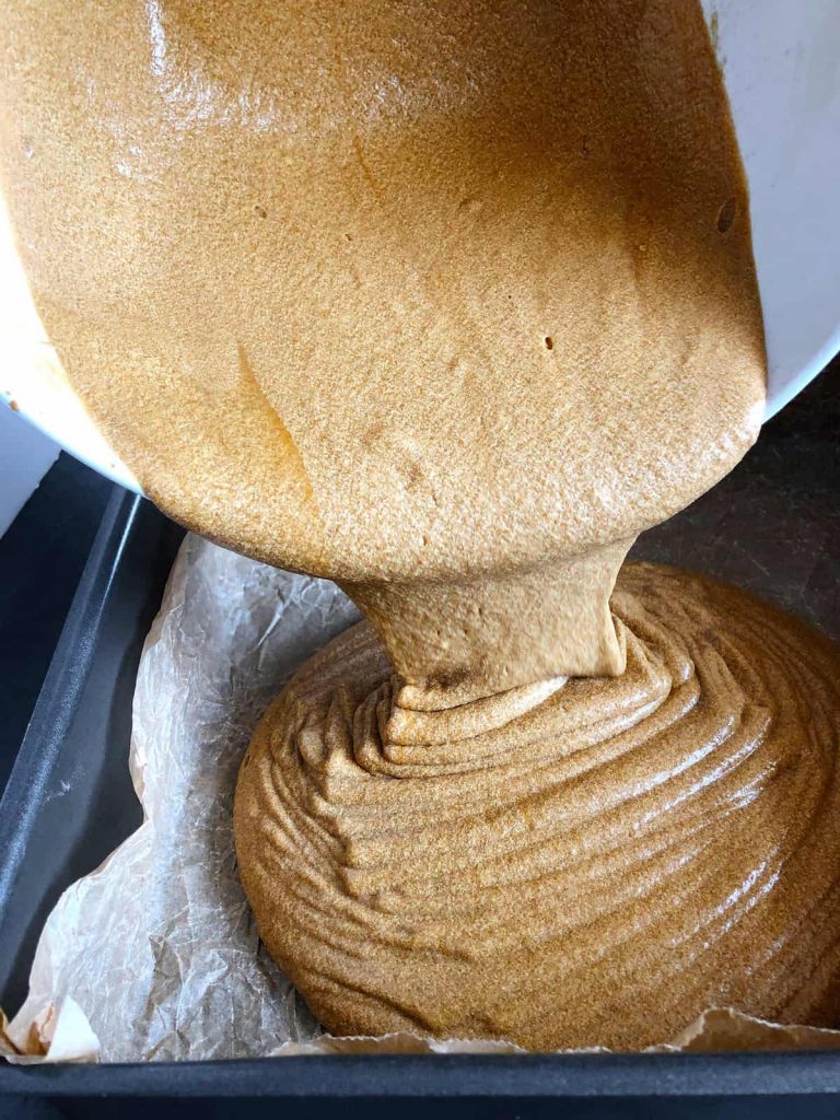 pouring batter into the cake tin