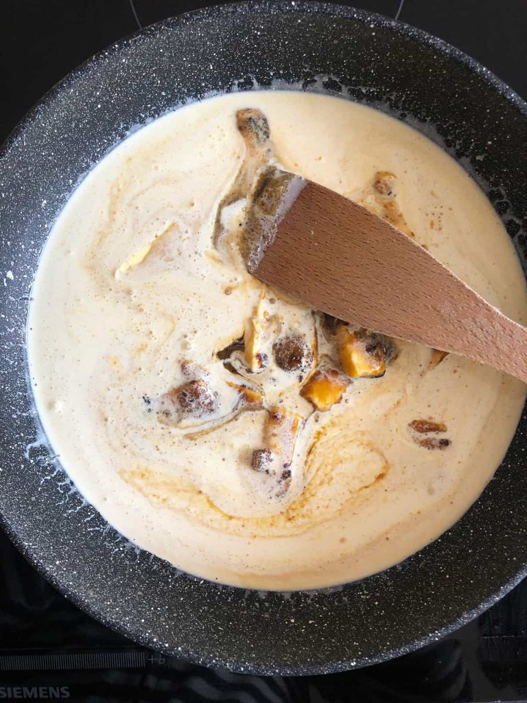 stiring sticky toffee sauce over a gentle heat