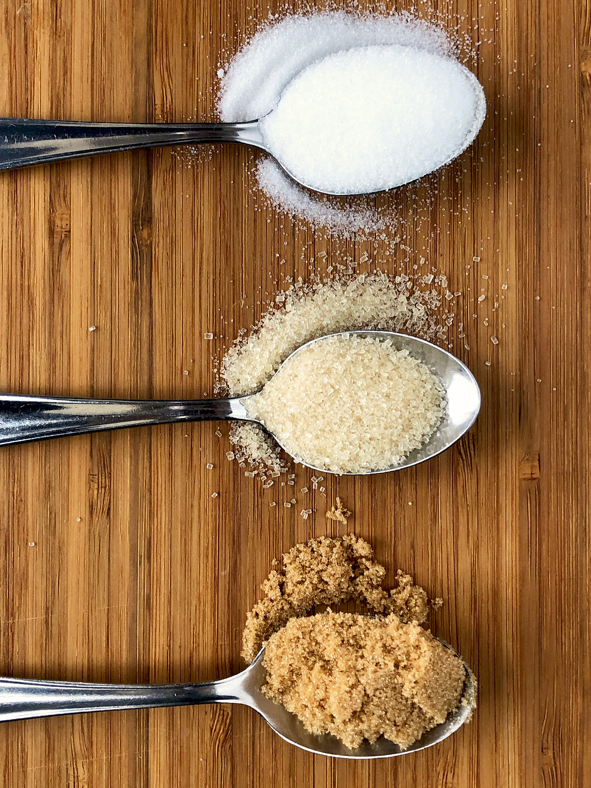 three teaspoons with caster,brown and light muscovado sugar