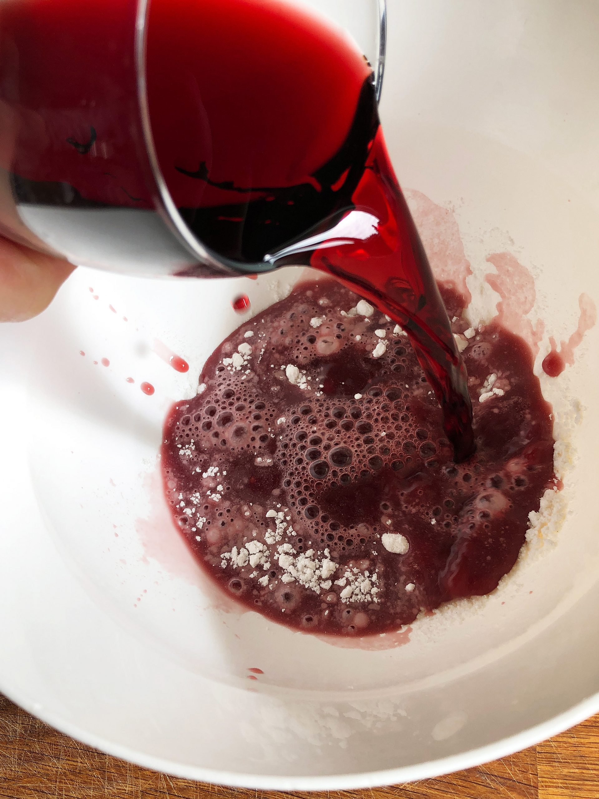 Mixing red wine with flour to thicken sauce