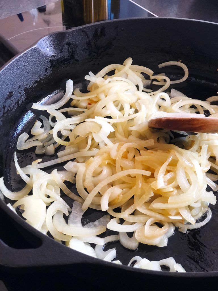 Browning onion in a cast-iron pan