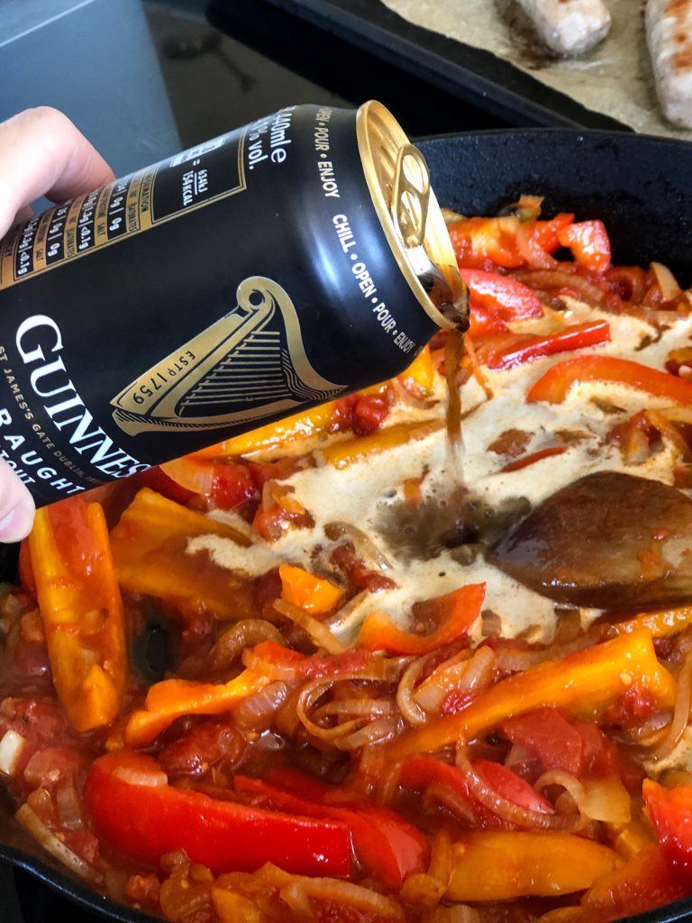 pouring Guinness into sausage casserole