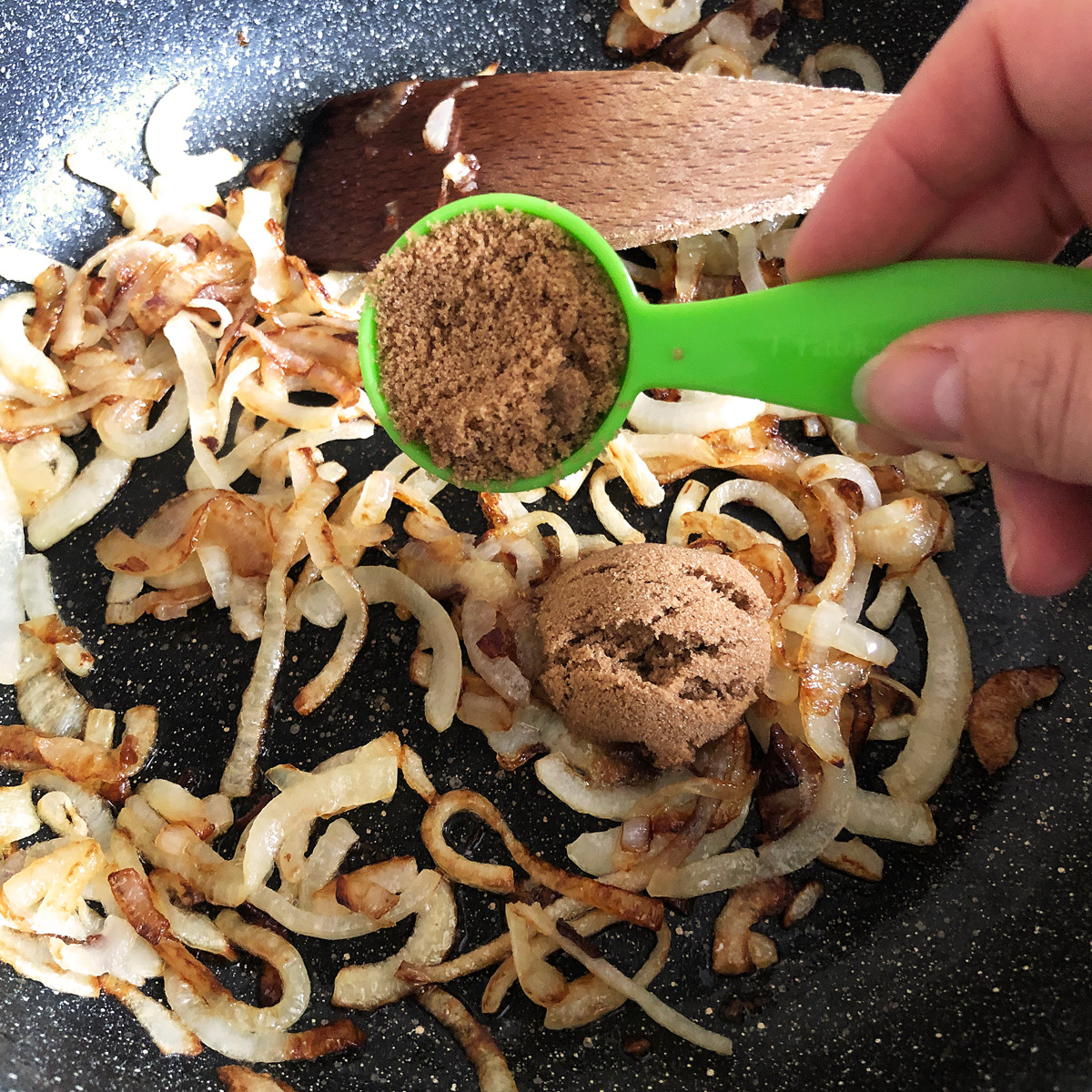 Adding two tablespoons of muscovado sugar into caramelised onion.