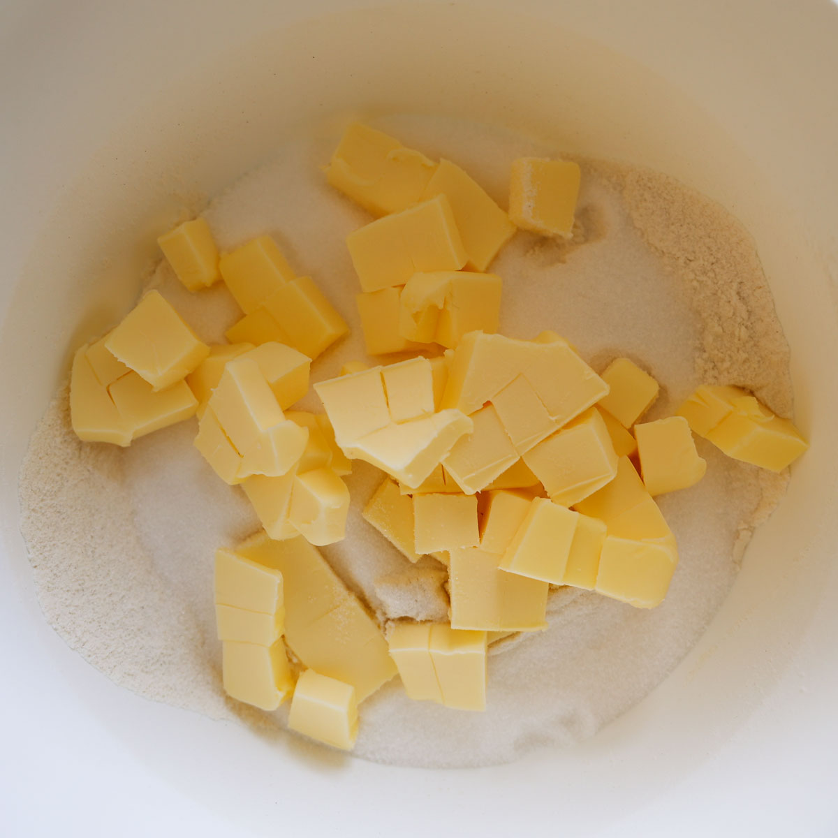 Flour, caster sugar and cubed butter in a mixing bowl.