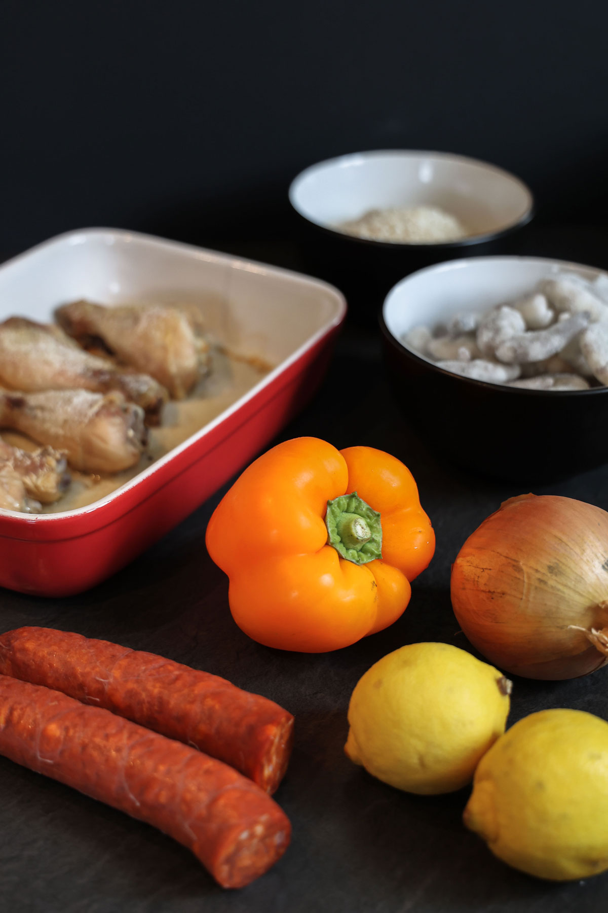 Selection of ingredients for making chicken chorizo and prawn paella.