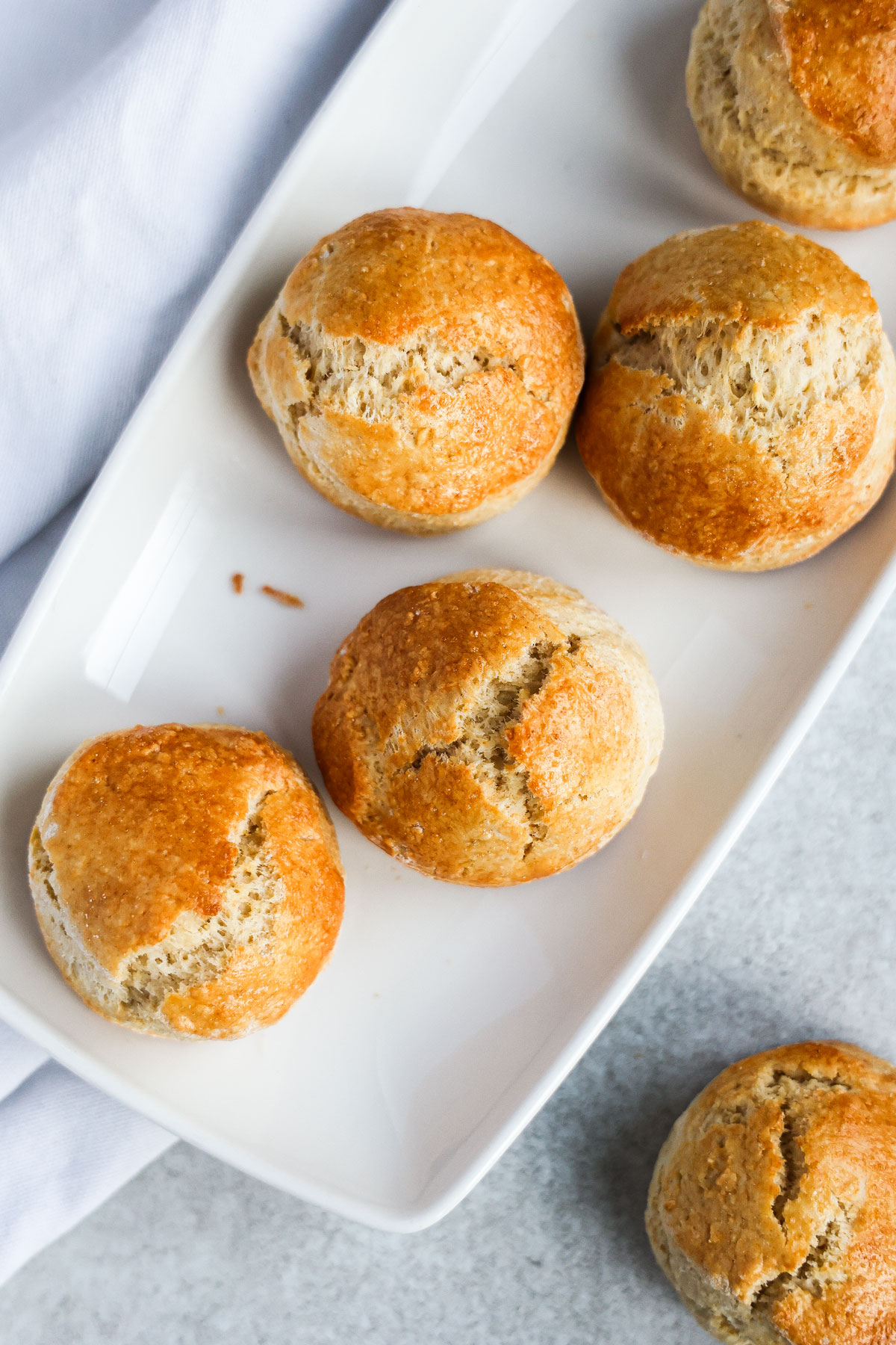 Scones placed on a white rectangular plate.