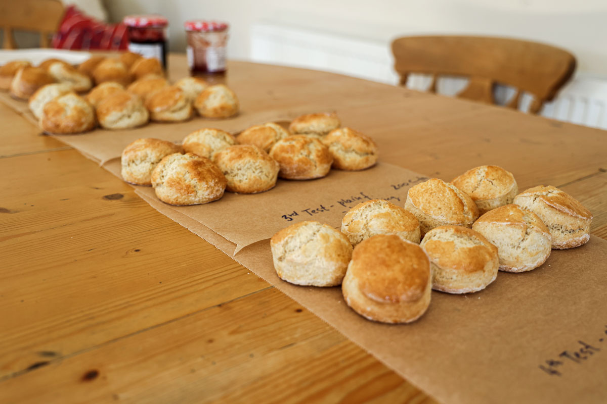 Four batches of scones on the table.