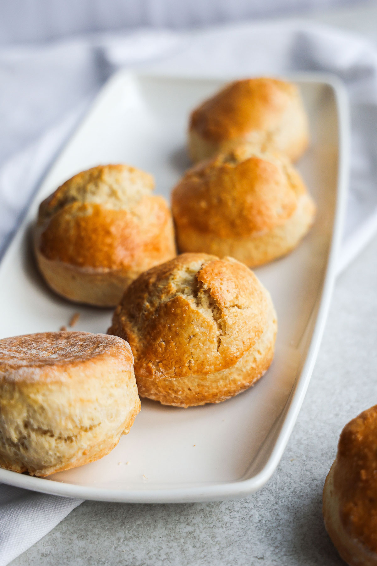 Scones placed on a white rectangular plate.