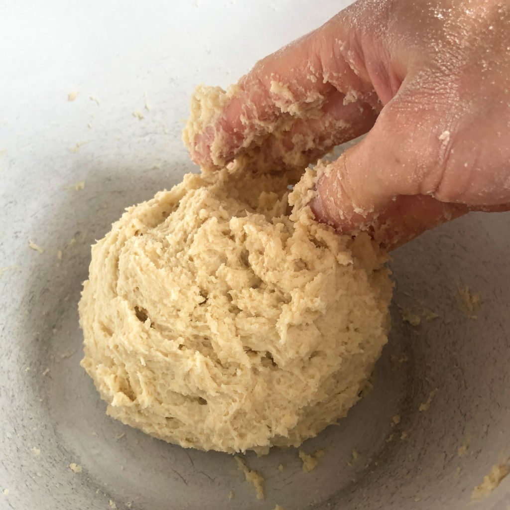 Sticky scone dough in a bowl.