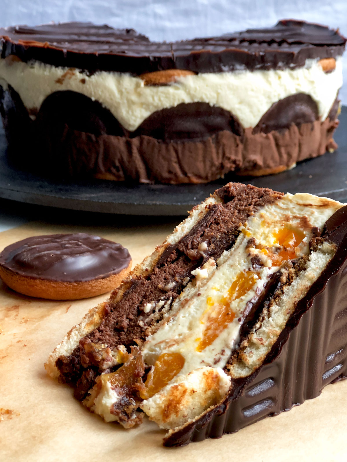 A slice of no-bake cake made of layers of Jaffa cakes, whipped cream and fruit.