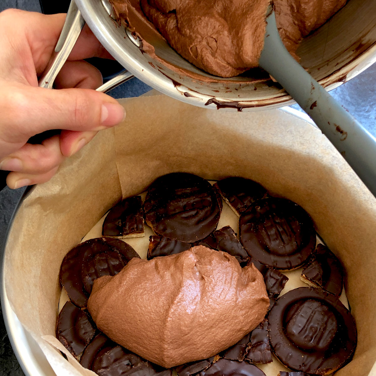 Covering Jaffa cakes with chocolate filling.