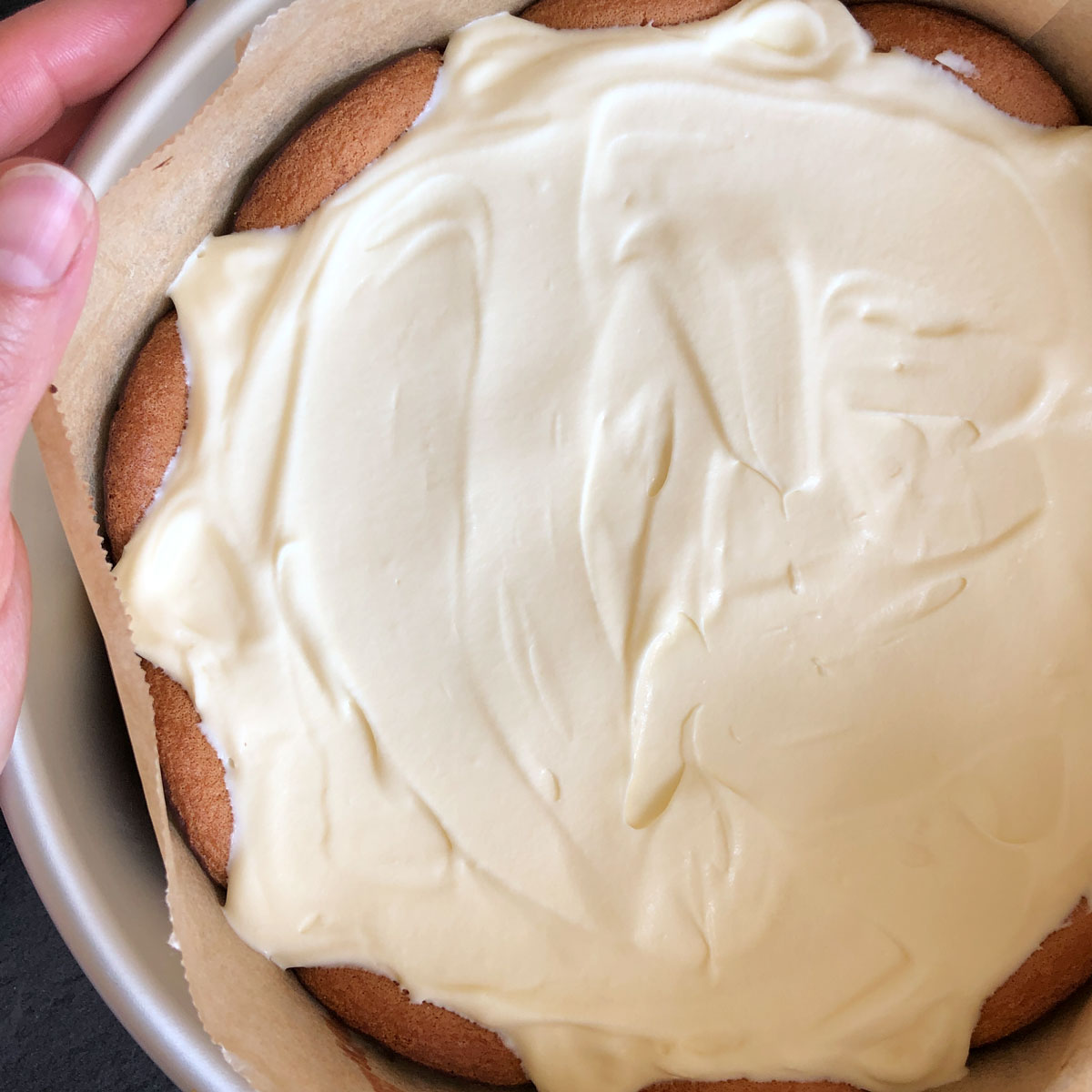 Even layer of whipped cream coverring Jaffa cakes.