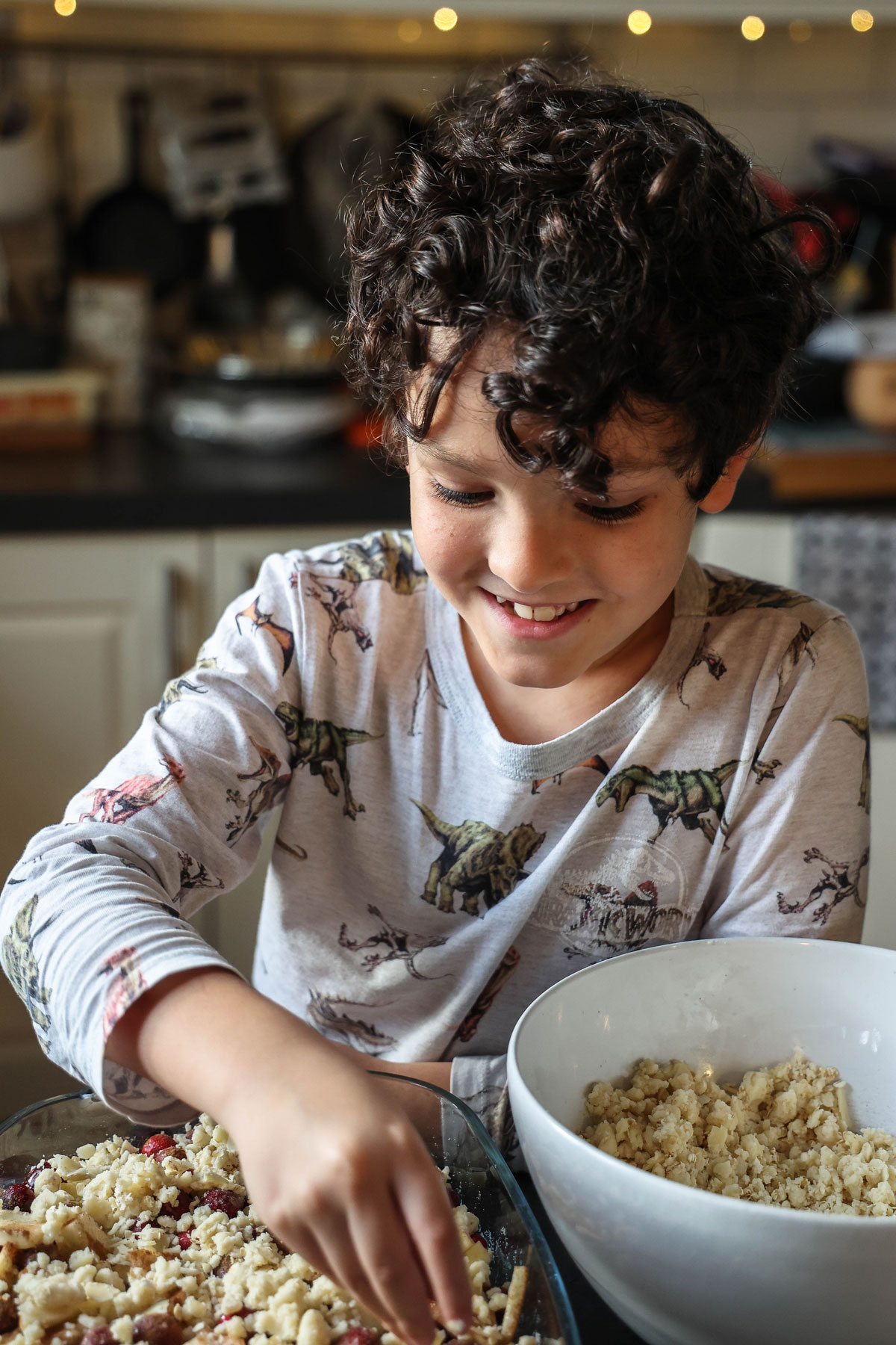 A boy preparing apple crumble.