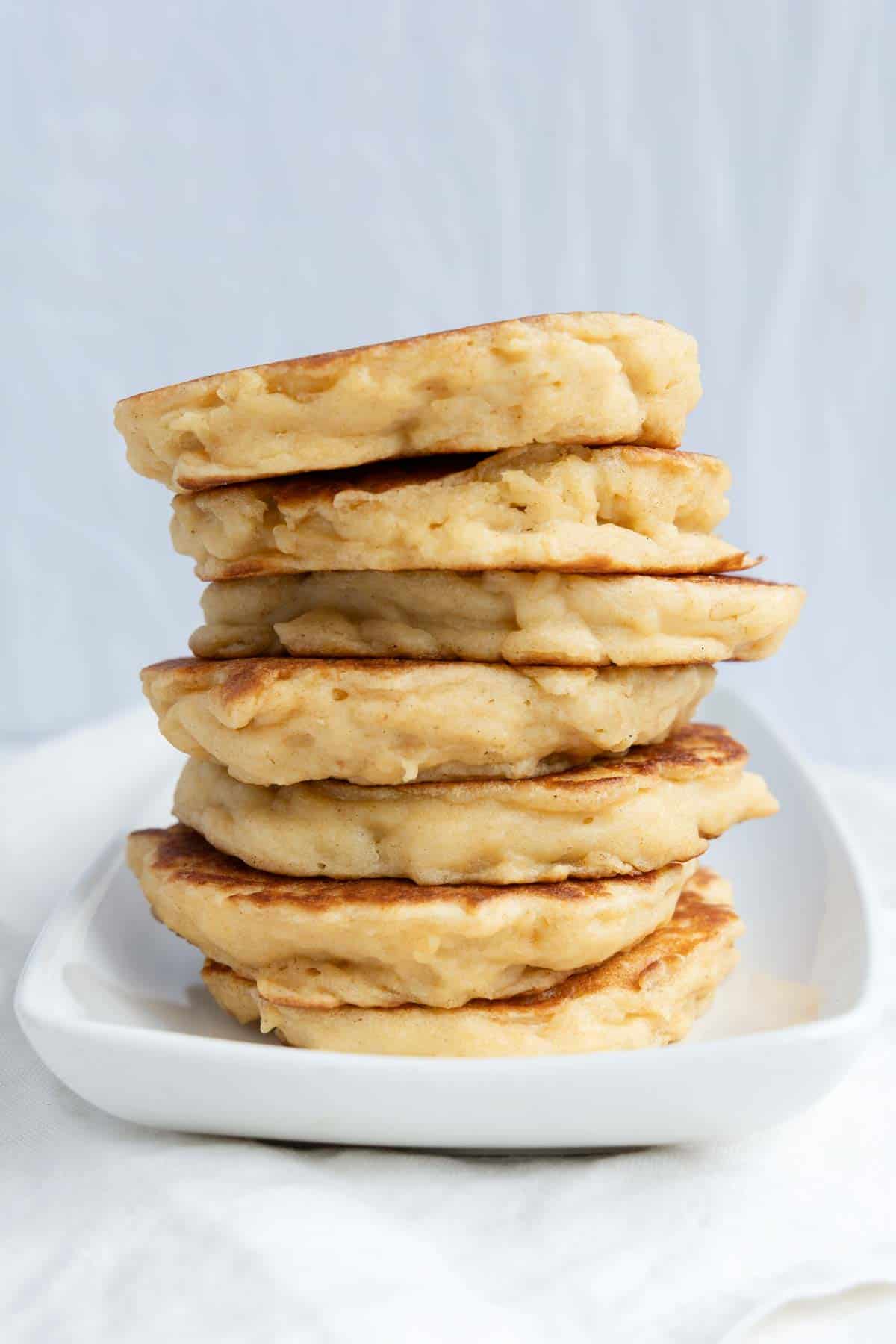 A stack of American-style pancakes on a white plate.