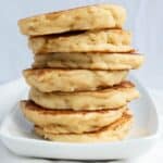 A stack of American-style pancakes on a white plate.
